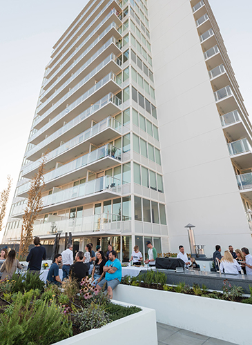A resident party on the rooftop garden patio at Pendrell by Bosa Properties
